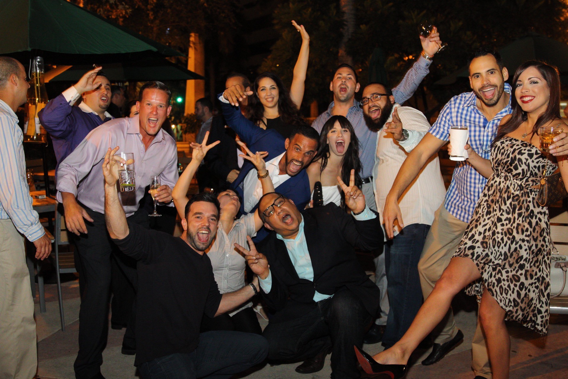 Office team making funny faces and laughing, while having fun at our Real Estate In The Biz Mixer.
